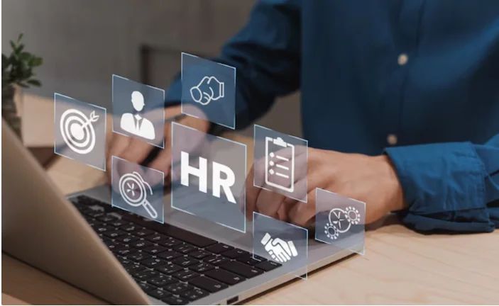 Man works on a laptop with floating HR icons for recruitment, targeting, and management overlaid on the screen.
