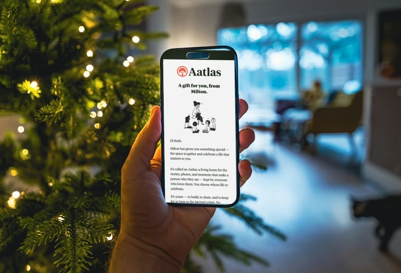 Hands holding a phone showing an Aatlas gift email