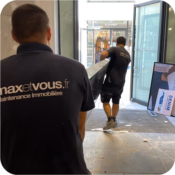 deux employés max et vous de dos en train de porter quelque chose de lourd