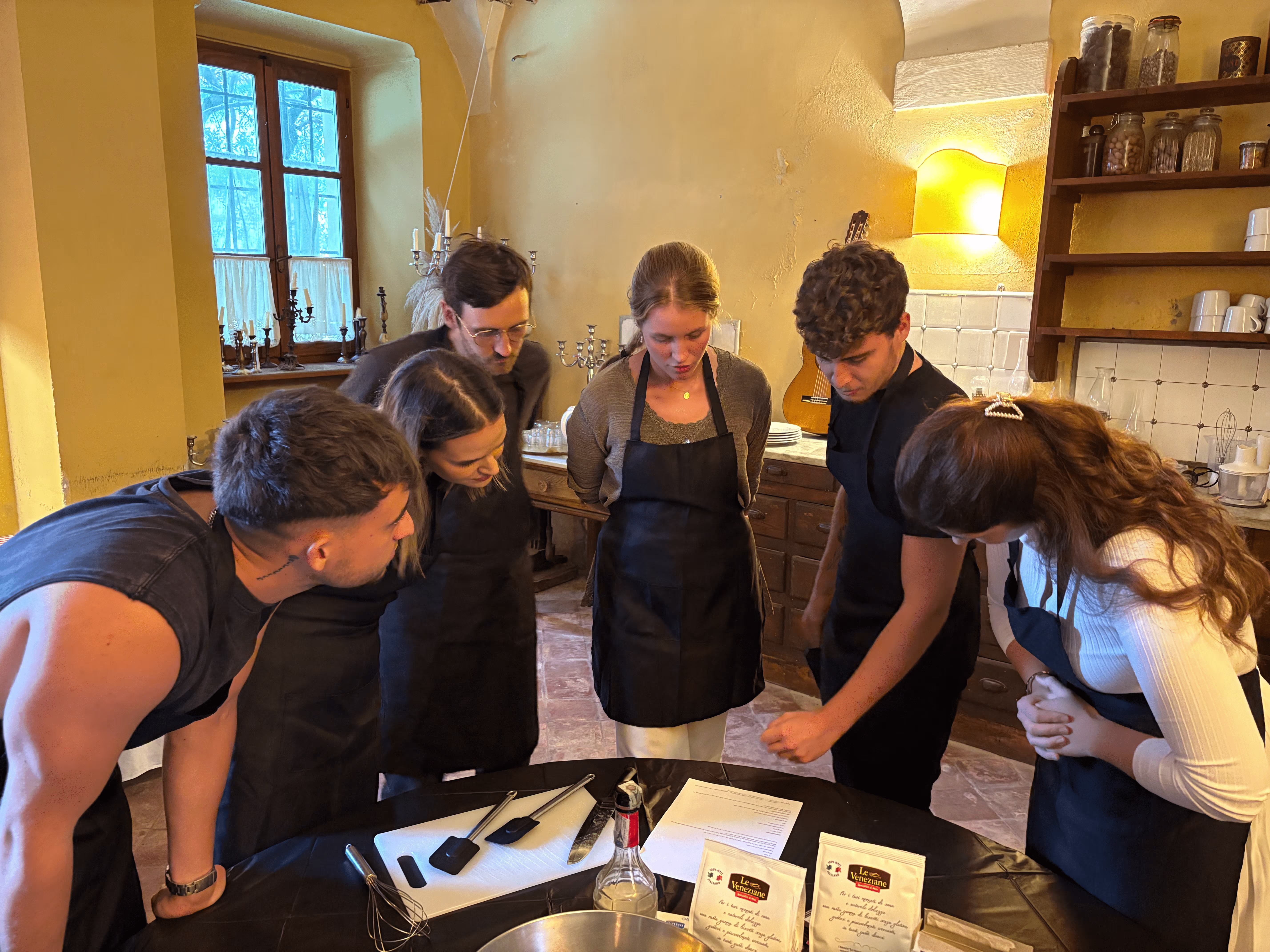 The Visium team gathered, reading the recipe as they're about to make pastries and pasta.