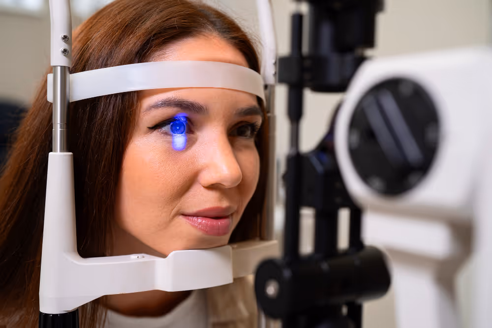 Patient undergoing eye exam with blue light ophthalmology equipment