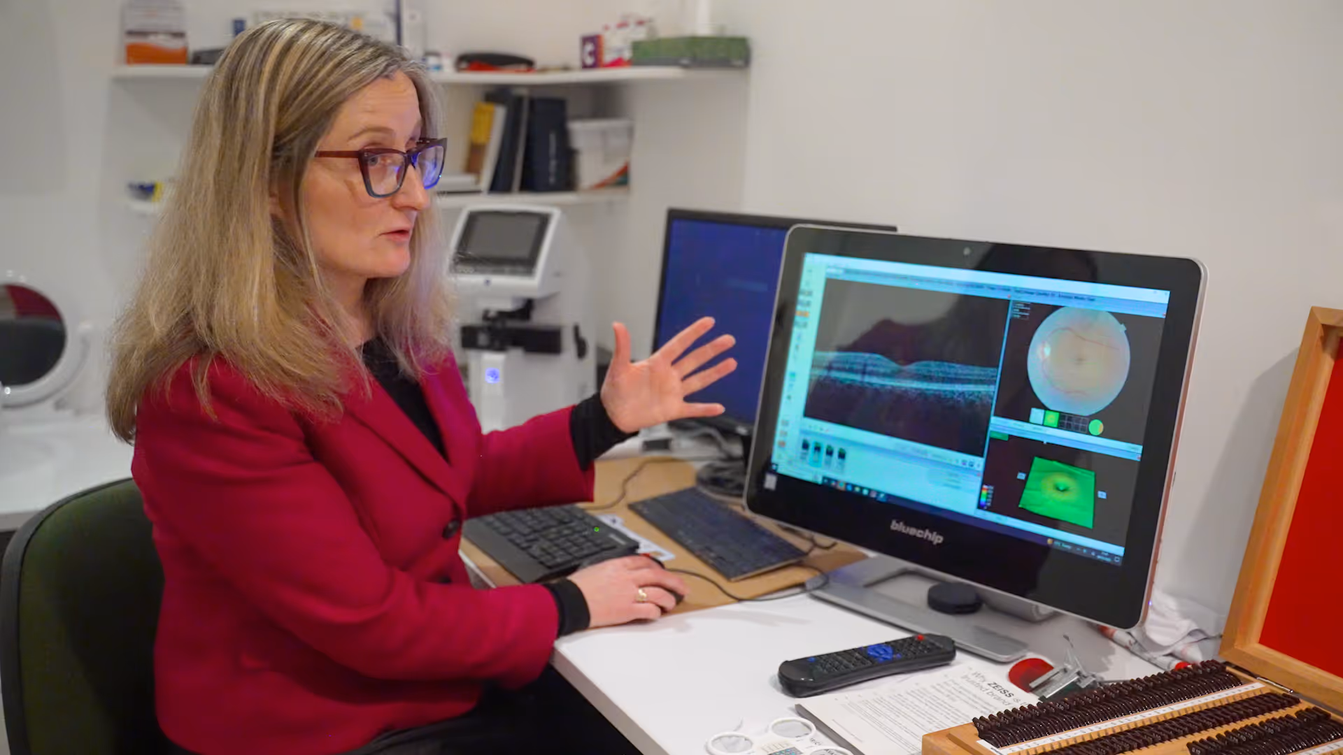 Researcher analyzing medical imaging data on computer screens in laboratory