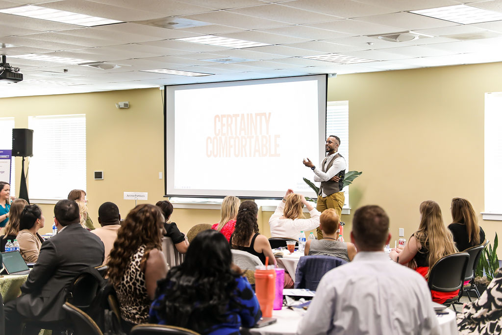 Darryl speaking to a room of education professionals