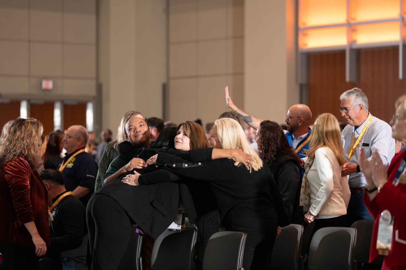 Educators hugging after the keynote