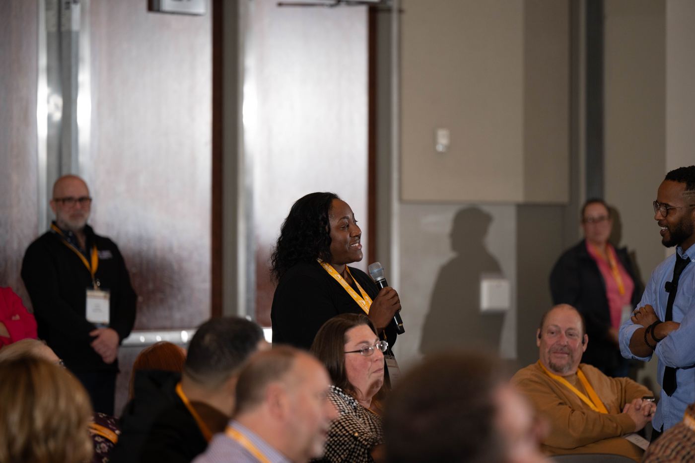An education leader speaking with a microphone in the room