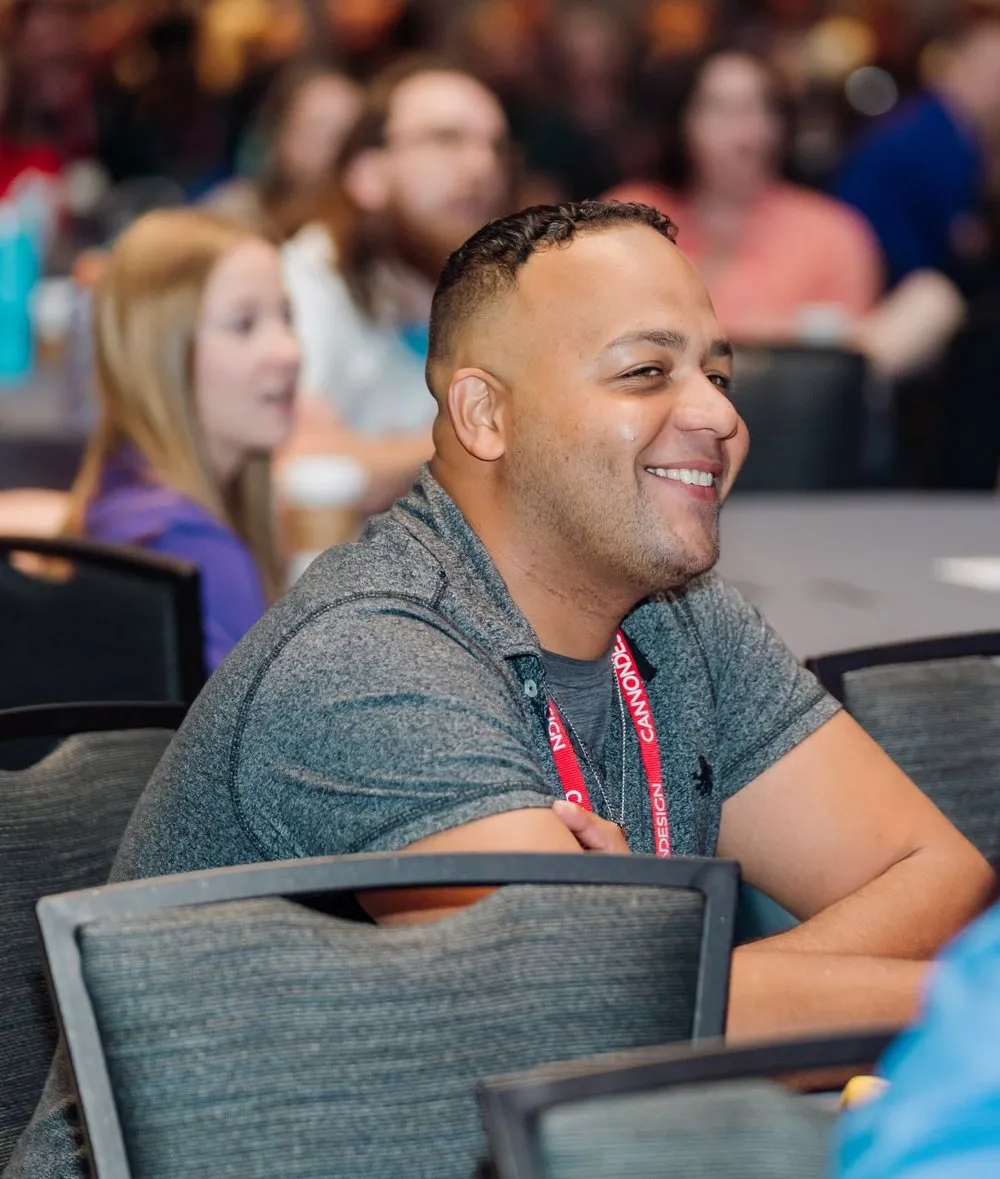 An attendee laughing at his table during Darryl Bellamy Jr.'s keynote