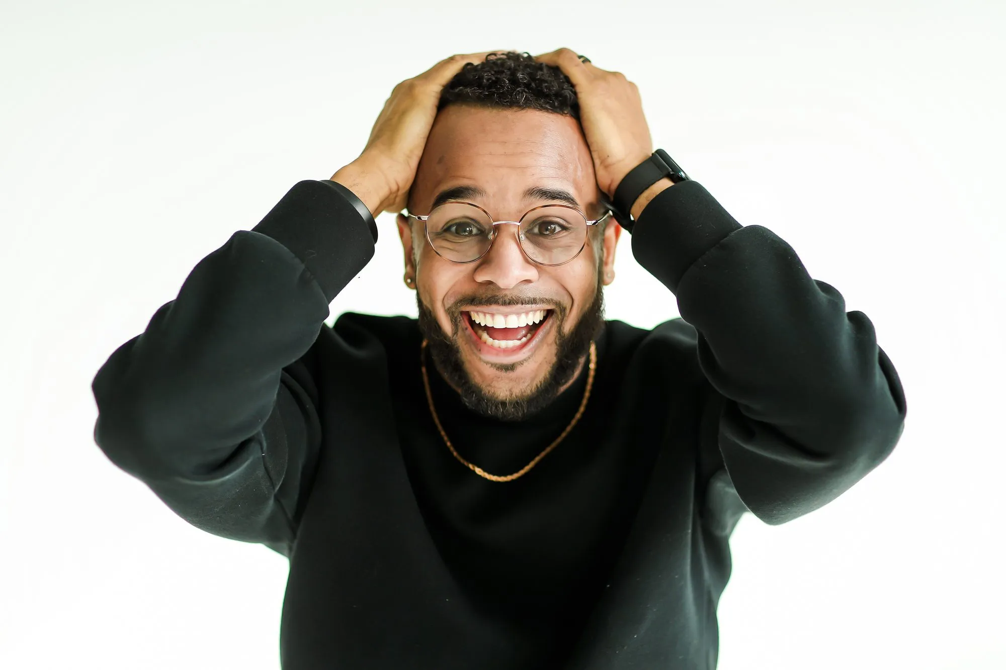 Darryl laughing with his hands on his head