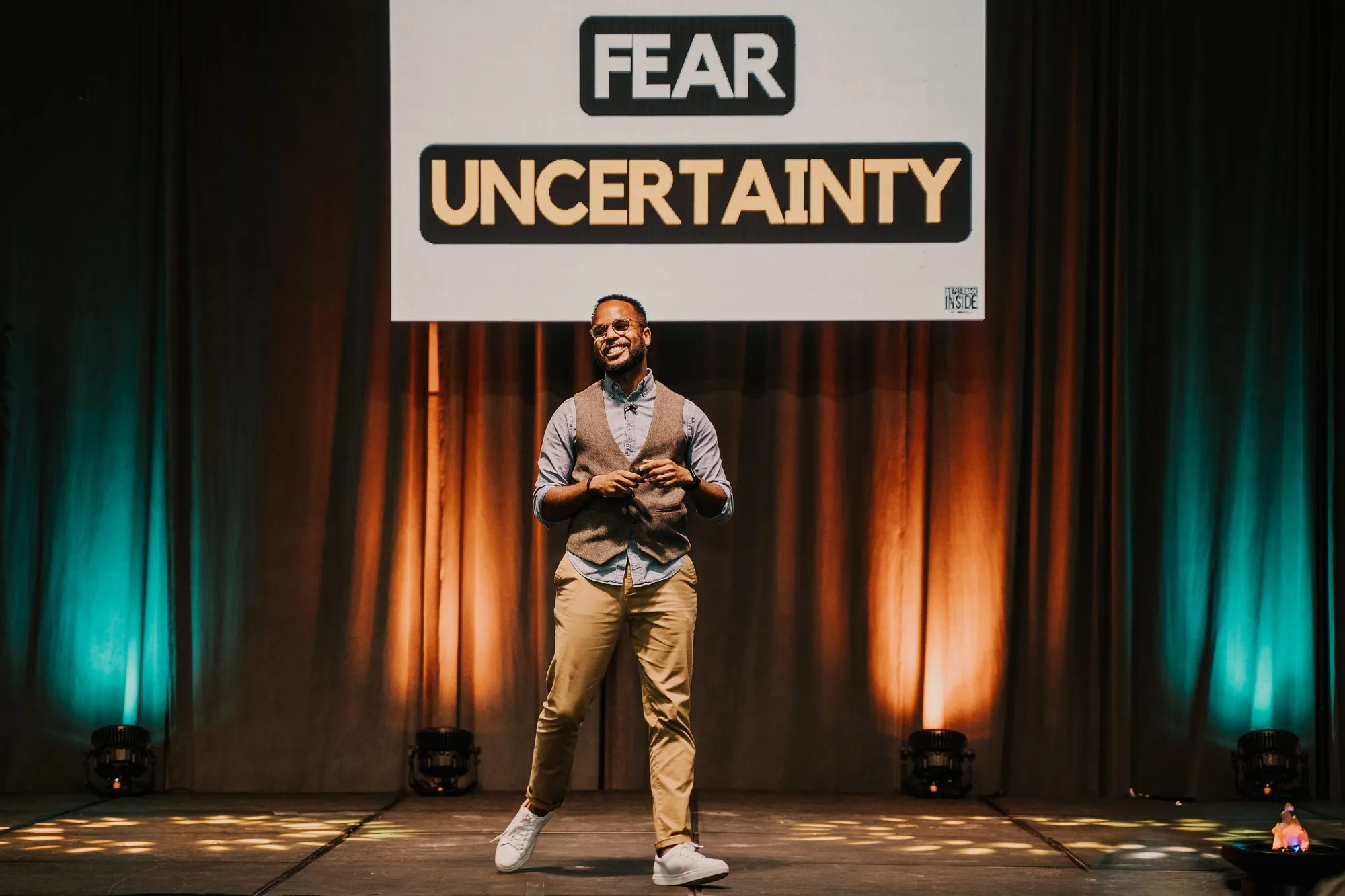 Darryl on stage under a Fear and Uncertainty slide