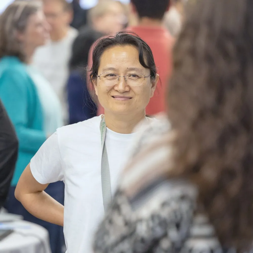 An educator smiling during a keynote activity