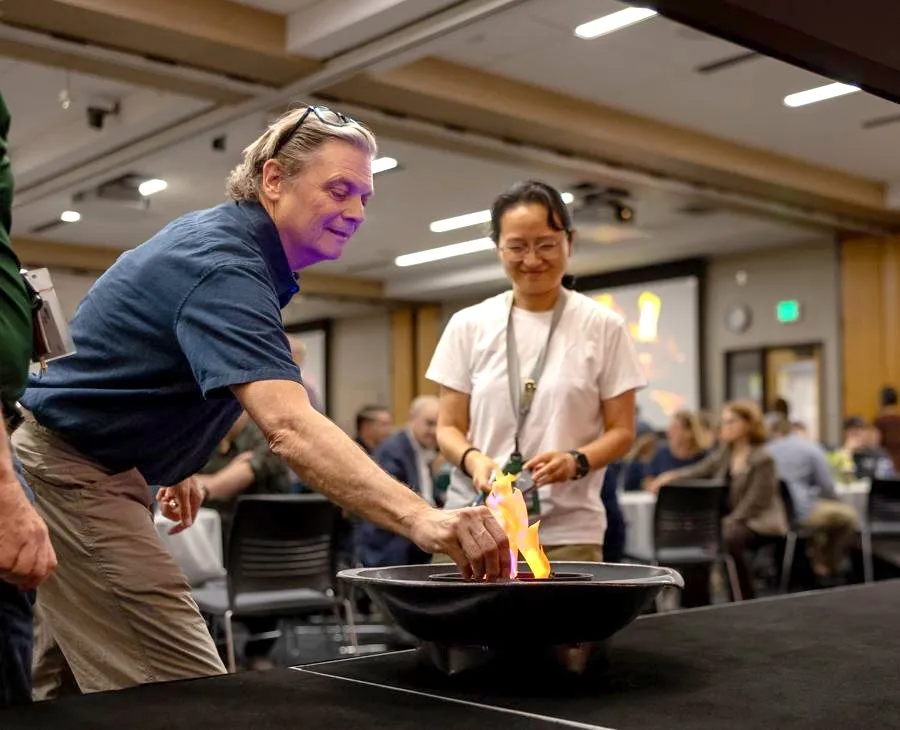 A staff member drops a fear card into the fire pit on stage