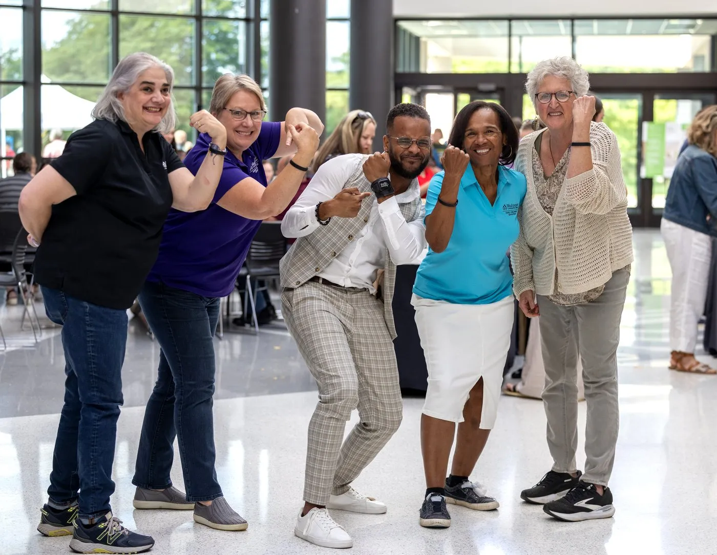 Washtenaw staff flexing to show their Fear(less) bands