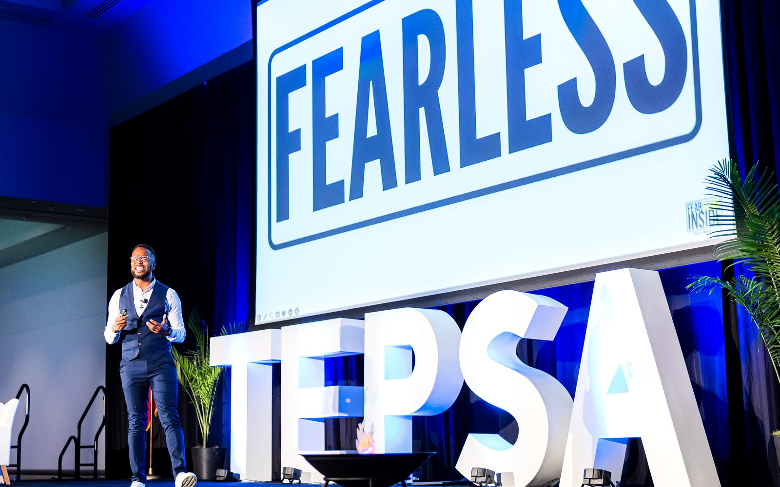 Darryl on stage at TEPSA under the big FEARLESS screen
