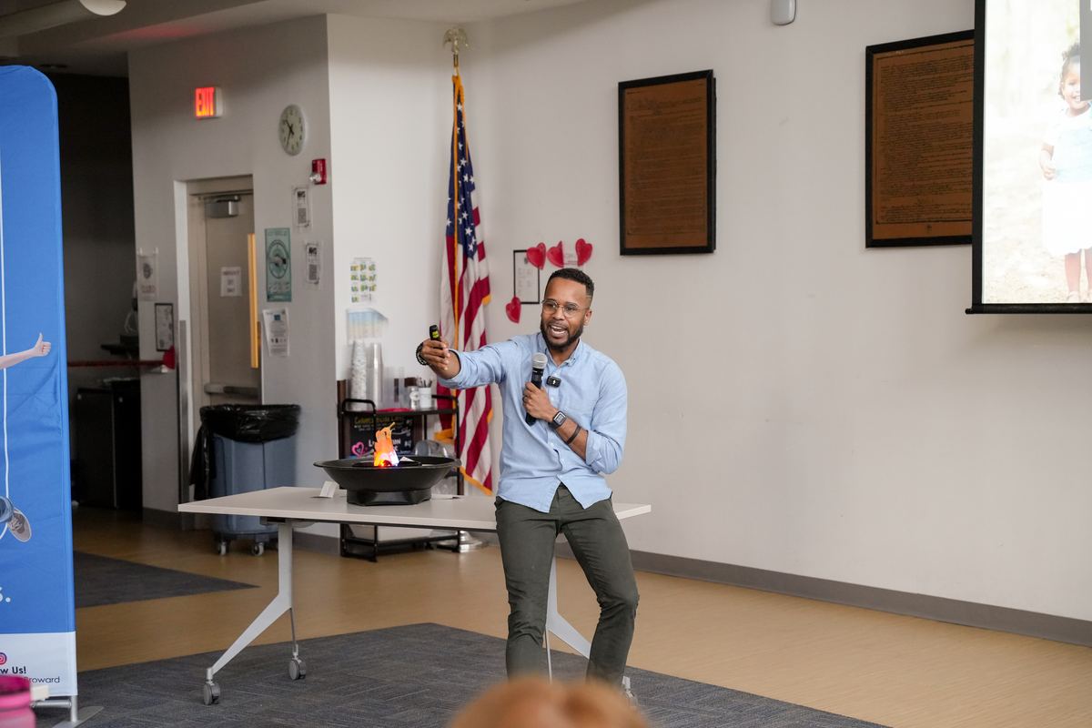 Darryl laughing on stage at a district opening day