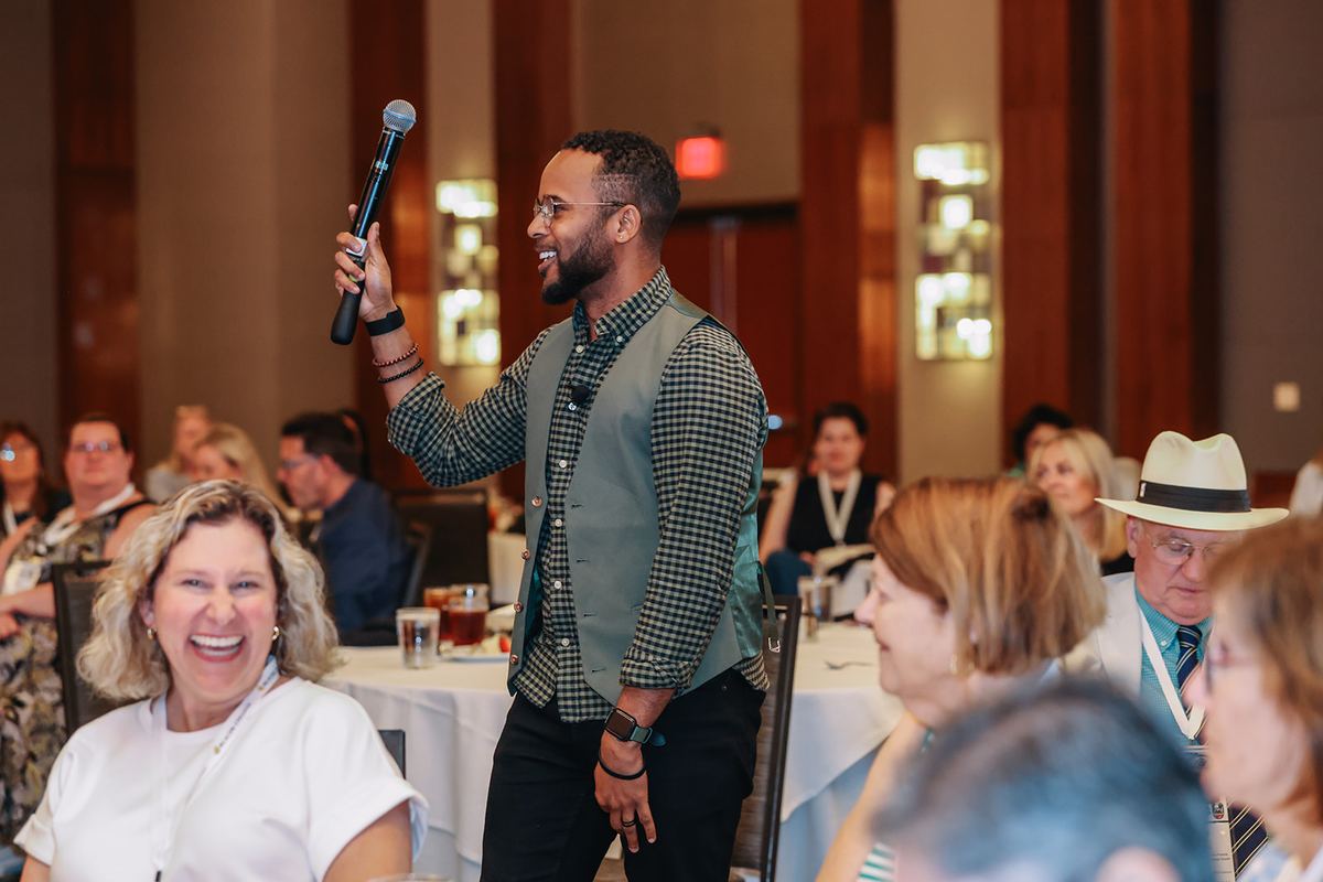 Darryl on stage at an education nonprofit's staff retreat