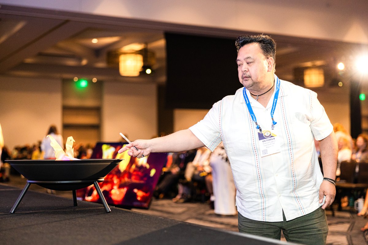 Education conference attendees lined up at the fire pit to release their fears