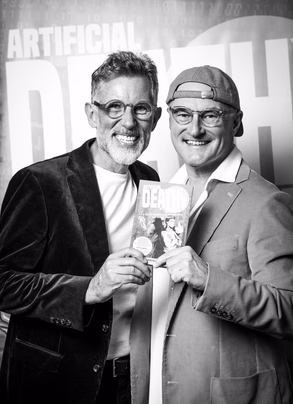 David Oxley and Helmut Schuster holding a copy of their latest book