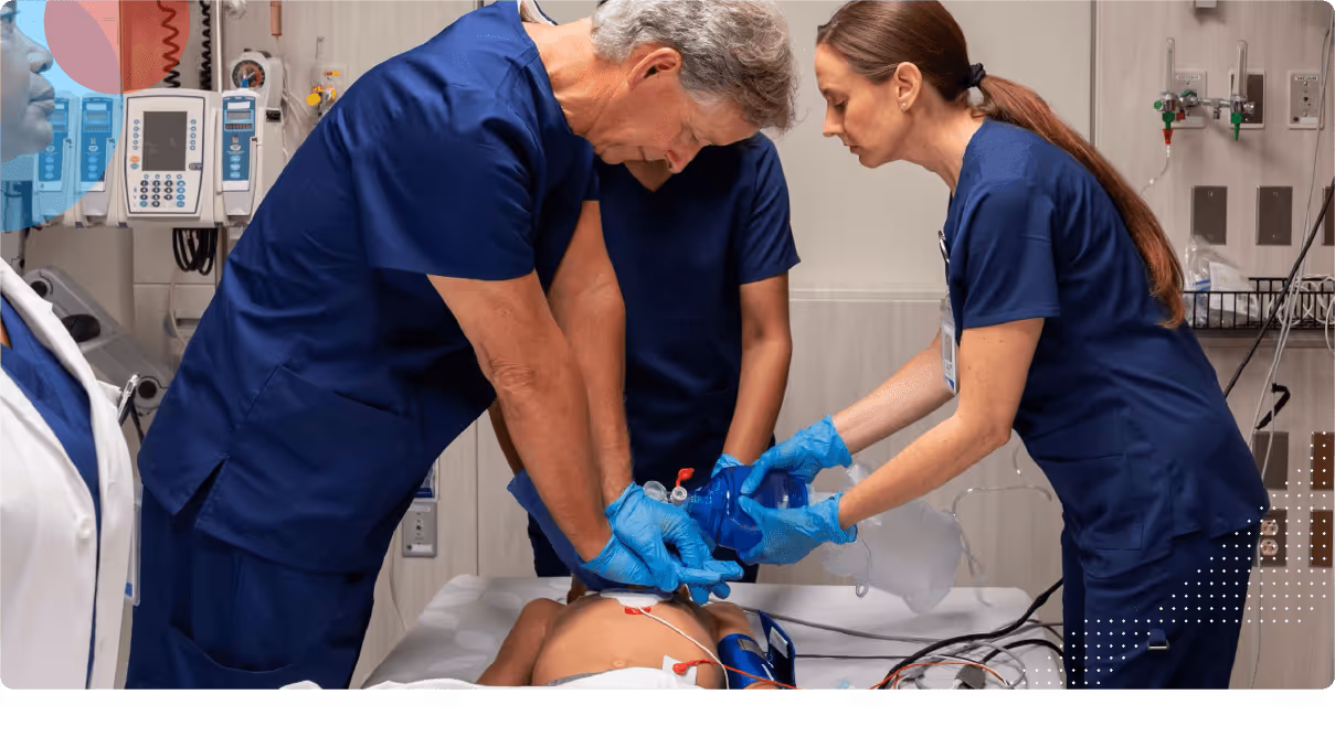 Medical professionals performing CPR and using a bag valve mask on a cpr dummy in a hospital room.