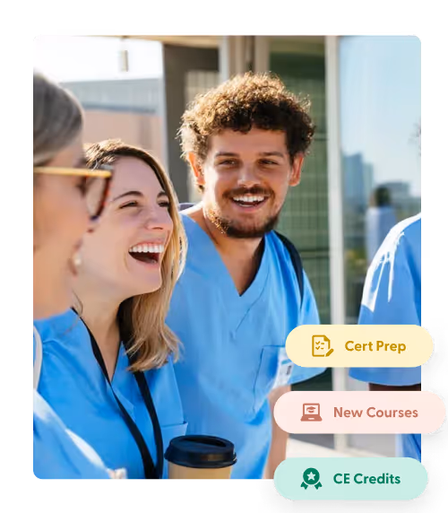 Group of smiling healthcare professionals in blue scrubs chatting outside a building.