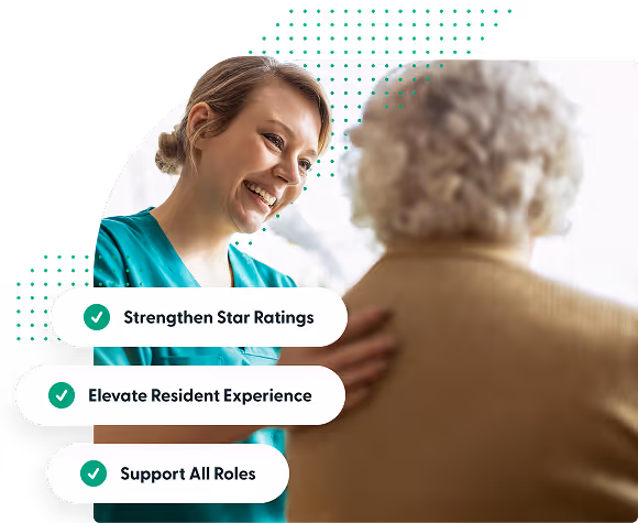 Smiling female caregiver in teal scrubs reassuring elderly person with white curly hair.