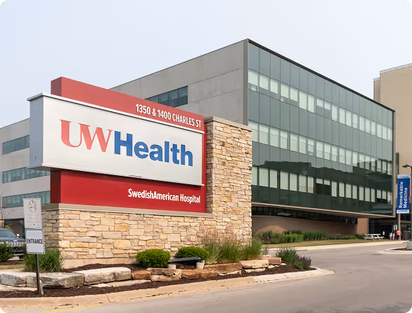 UW Health SwedishAmerican Hospital building with sign showing address 1350 & 1400 Charles St.