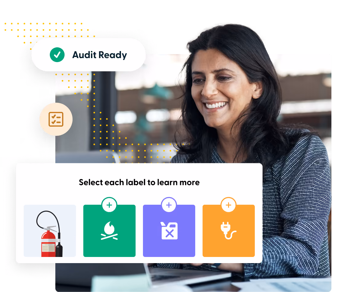 Smiling woman at laptop with a graphic showing fire safety icons and audit ready checkmark.