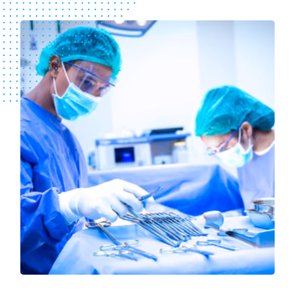 Two surgeons in masks and gloves preparing surgical instruments on a sterile table in an operating room.