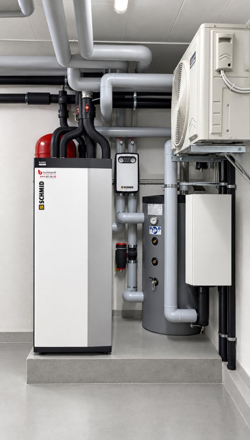 New NIBE heat pump installed on a small plinth in a plant room in Zumikon