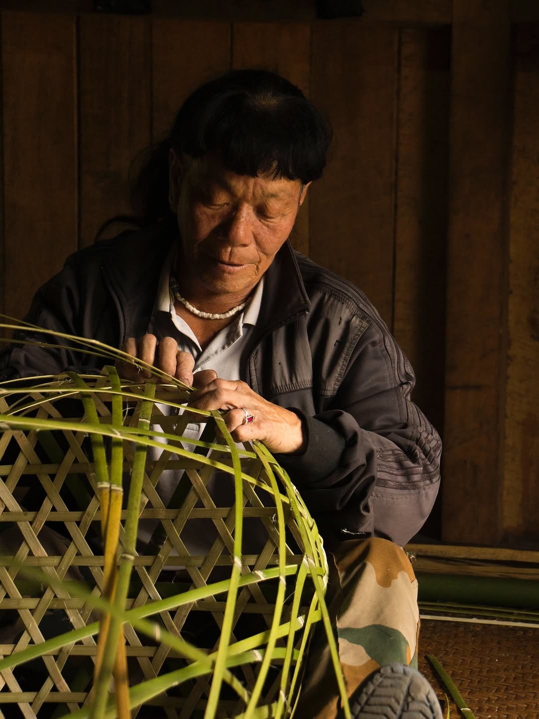 An indeginous artists from the Idu Mishmi community of Arunachal Pradesh, India, weaving a basket out of Bamboo