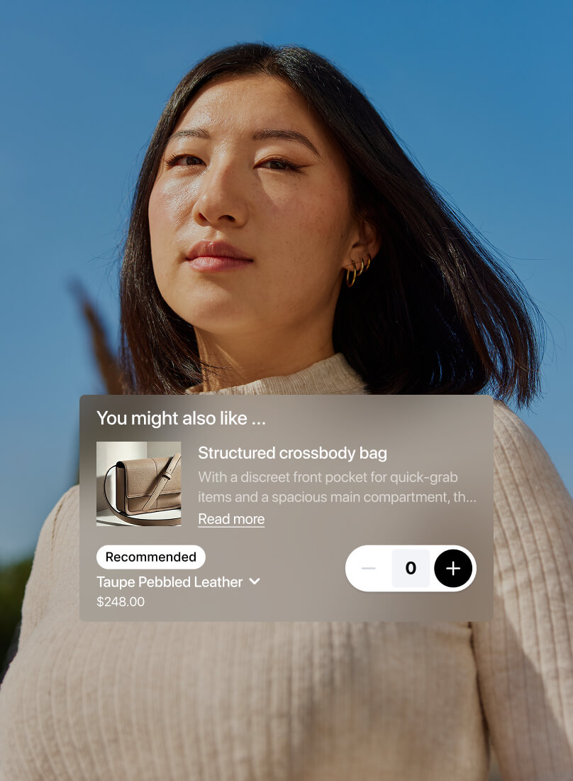 A woman stands confidently outdoors in front of a clear blue sky, wearing a light beige ribbed top. A product recommendation overlay suggests a structured taupe pebbled leather crossbody bag priced at $248, featuring a front pocket and spacious interior, with options to adjust quantity.