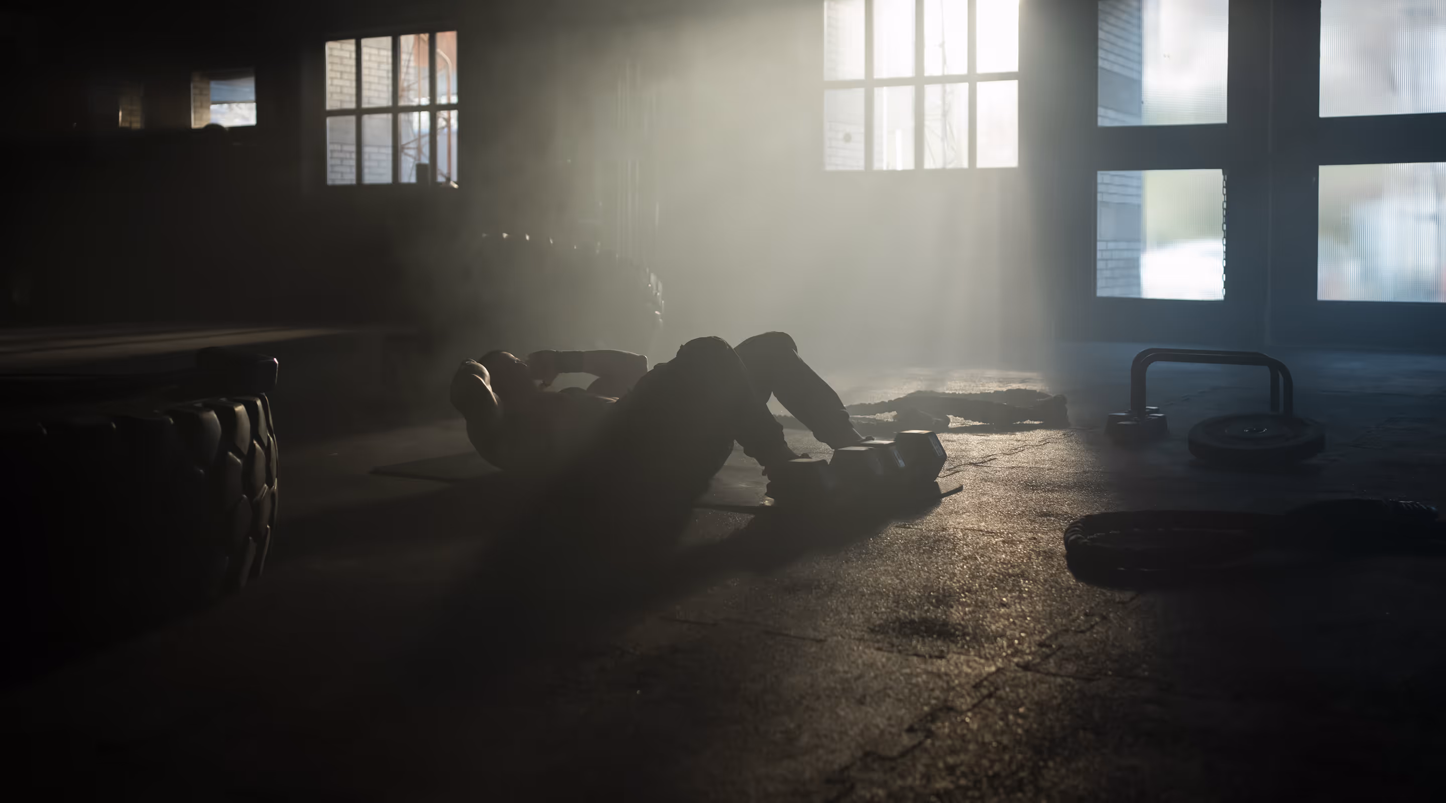 A person laying on the ground in a dark room.
