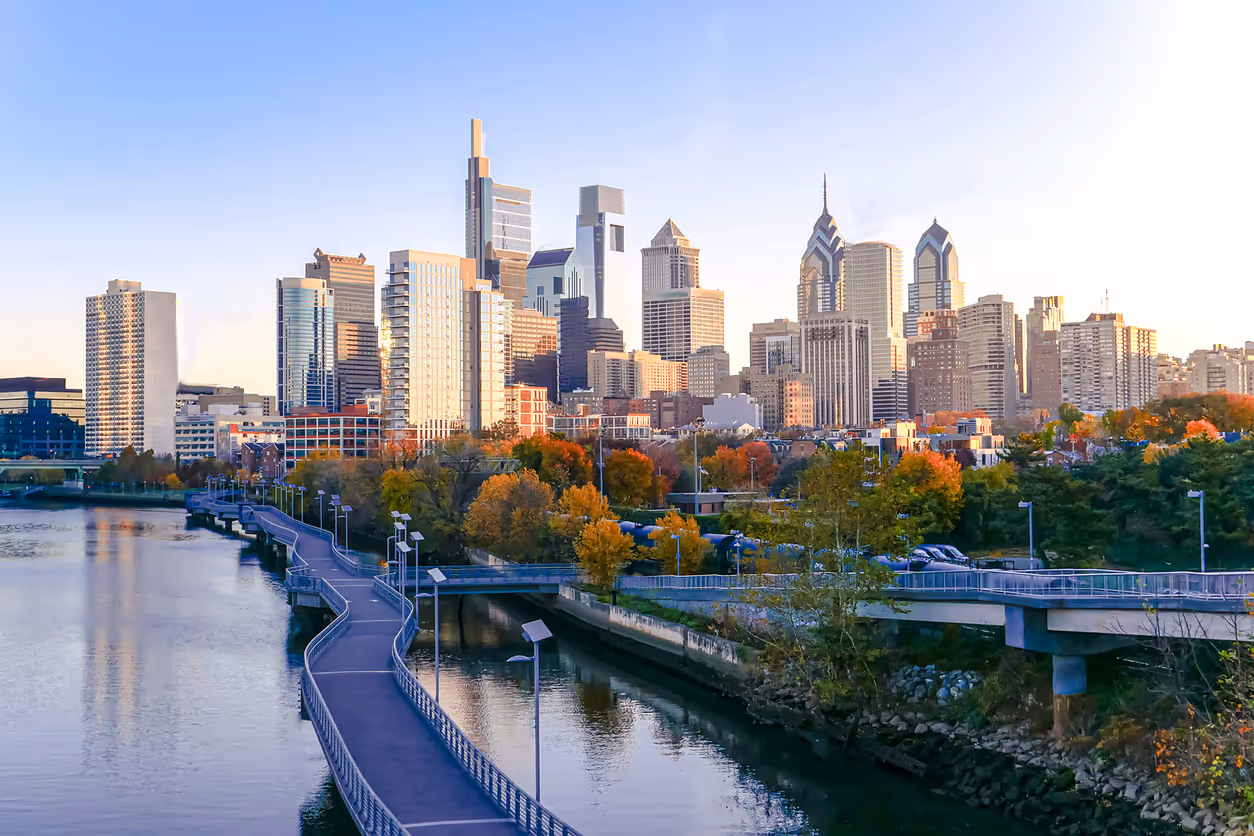 Philadelphia skyline with autumn trees and Schuylkill River walkway