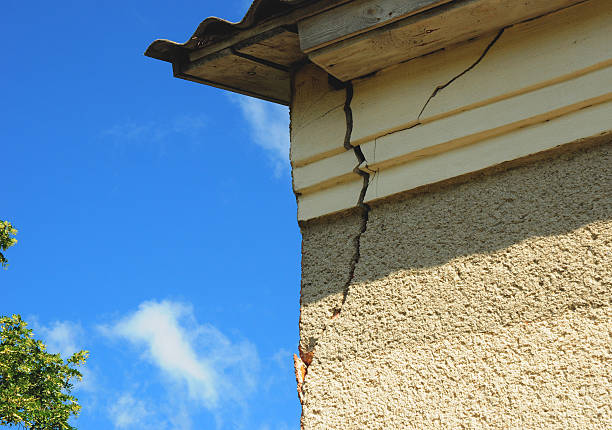 Large vertical crack running down the side of a stucco building