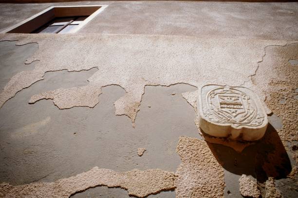 Ornate wooden stamp on textured concrete surface with cracked patterns