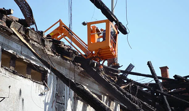 Orange lift on damaged roof during demolition or repair work