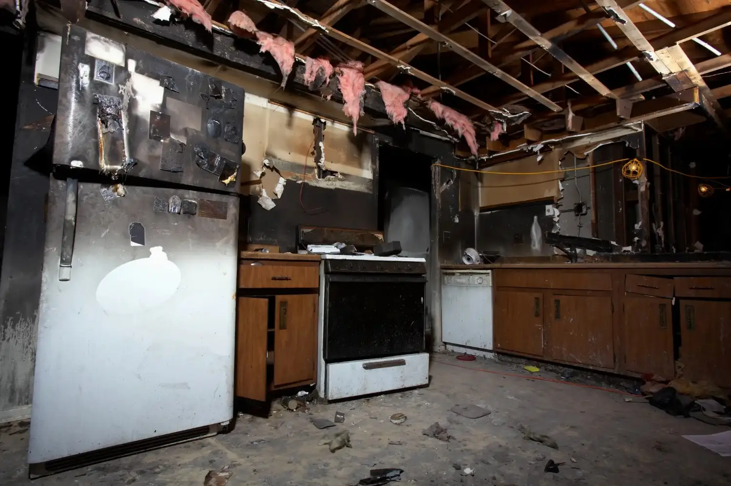 Damaged ceiling with broken tiles, water stains, and exposed structural elements