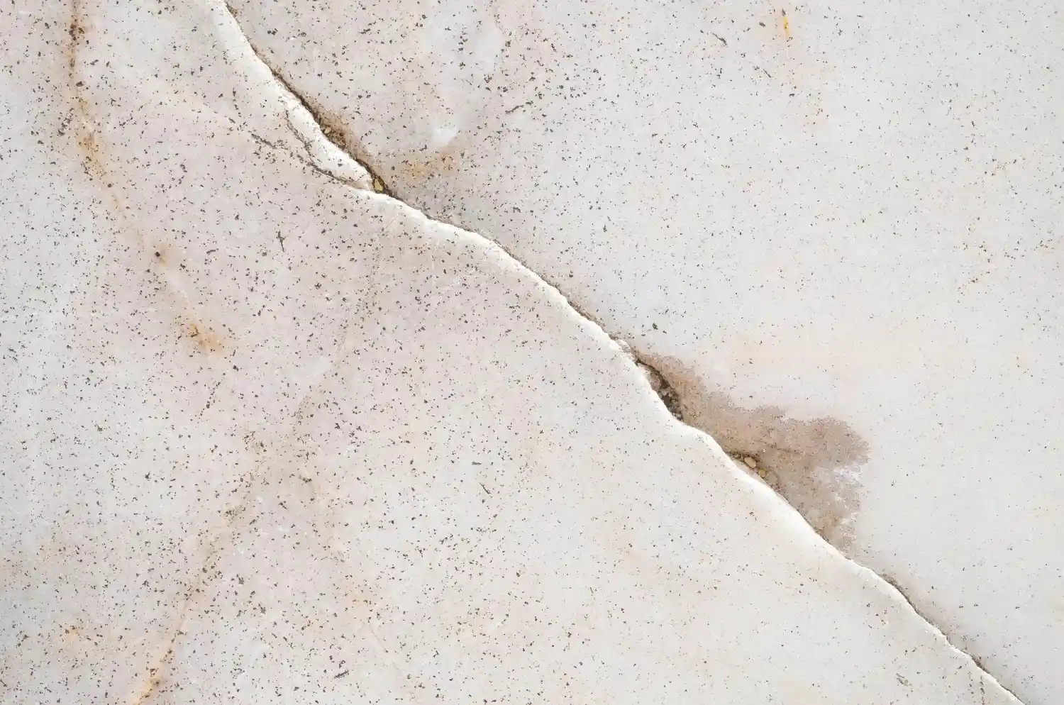 Water droplets falling from cracked ceiling, revealing water damage