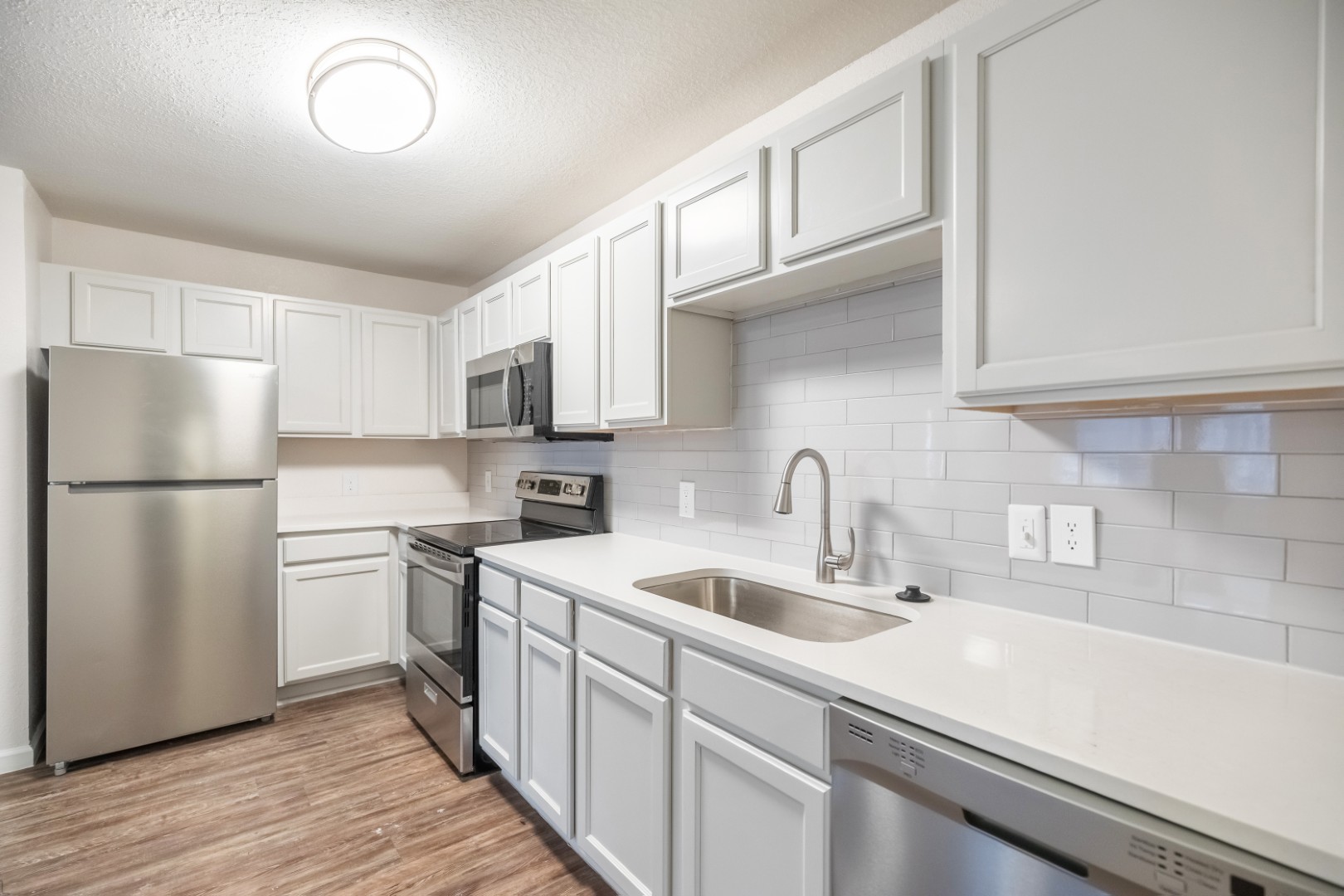 Renovated Kitchen with upgraded countertops at The Grand at Buffalo Run Apartments in Abilene, Texas
