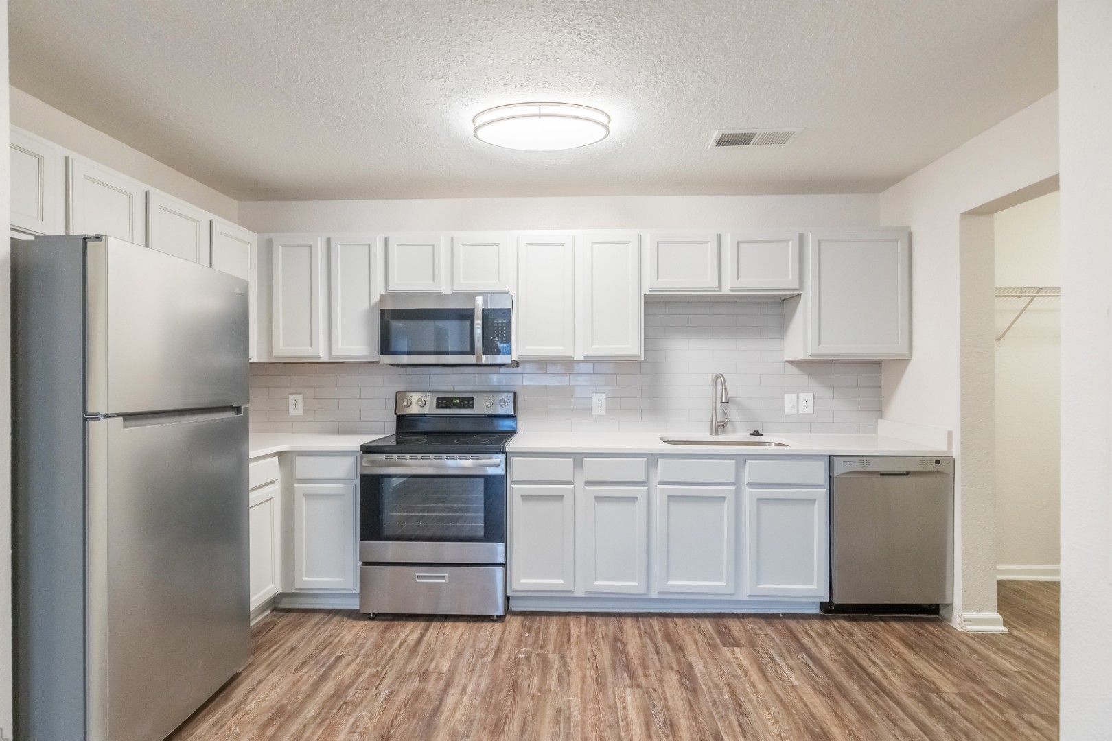 Renovated Kitchen with Stainless Steel Appliances at The Grand at Buffalo Run Apartments in Abilene, Texas