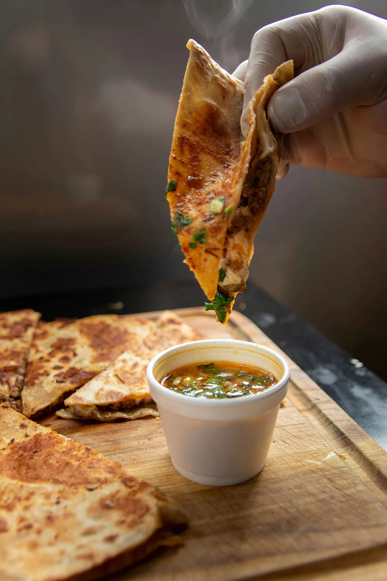 A "Gringa" taco with some birria soup