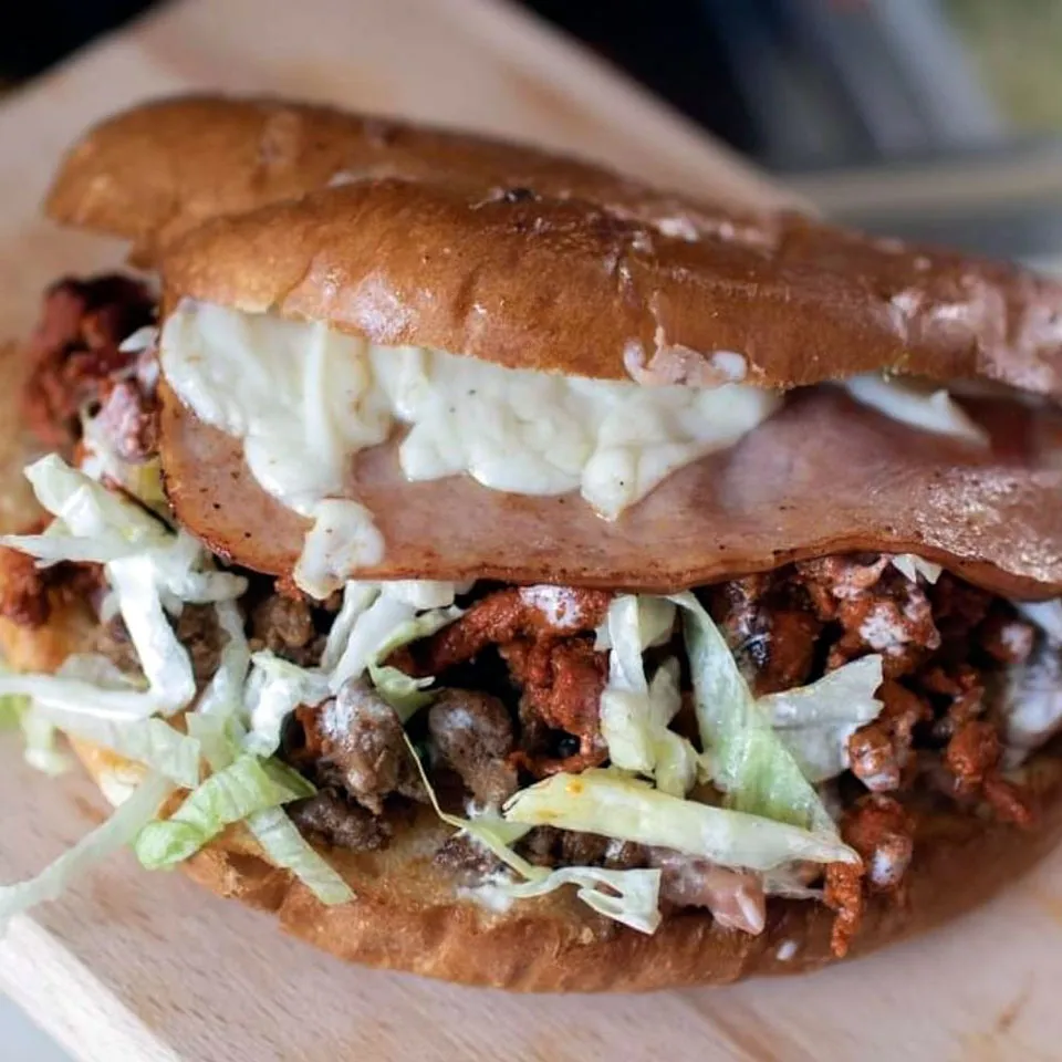 VIP Torta, Asada, al pastor y ham. served with lettuce, tomatoes and sour cream.