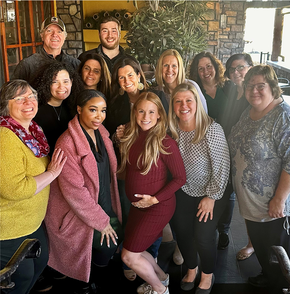 IFI team members gathered outside the office for a group photo during a team event.