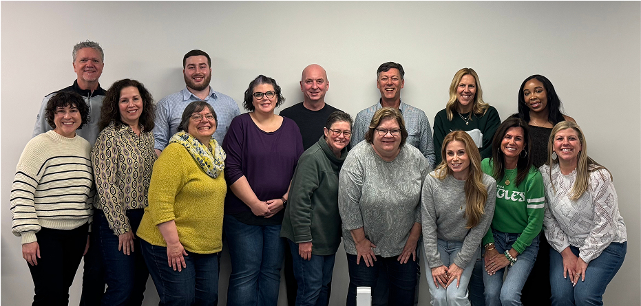 The IFI team smiling together for a company group picture.