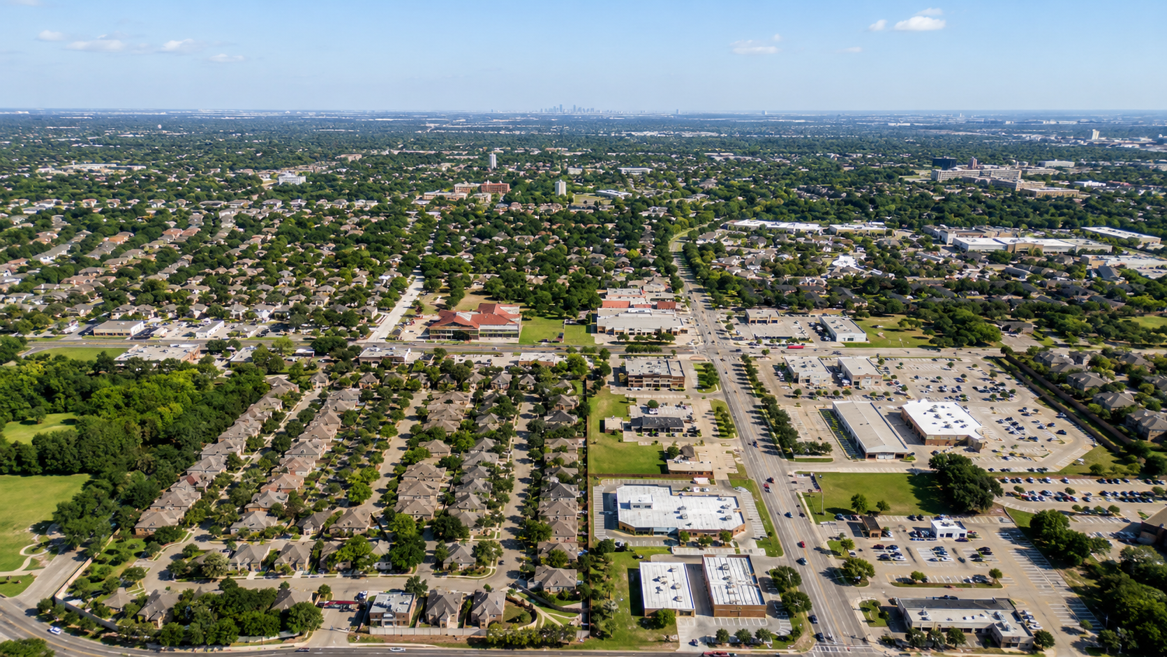 Aerial view of Bedford, Texas, showing tree-lined neighborhoods and commercial streets.