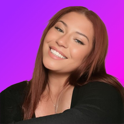 Smiling woman with long brown hair wearing a black top against a purple and pink gradient background.