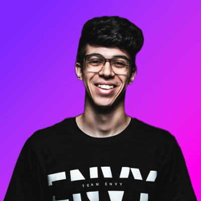 Smiling young man with glasses wearing a black Team Envy t-shirt against a purple and pink gradient background.