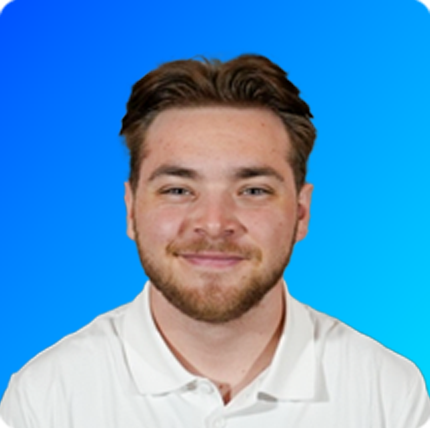 Smiling young man with glasses and dreadlocks wearing a light beige sweater against a bright blue gradient background.