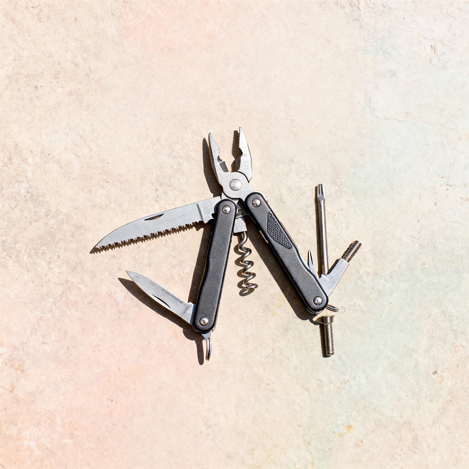 a multitool with pliers, wire cutters, a knife, a saw and screwdrivers