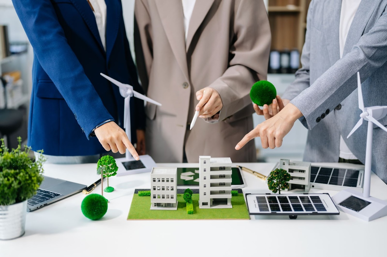 Group of Professionals observing a construction model to make it green and sustainable.