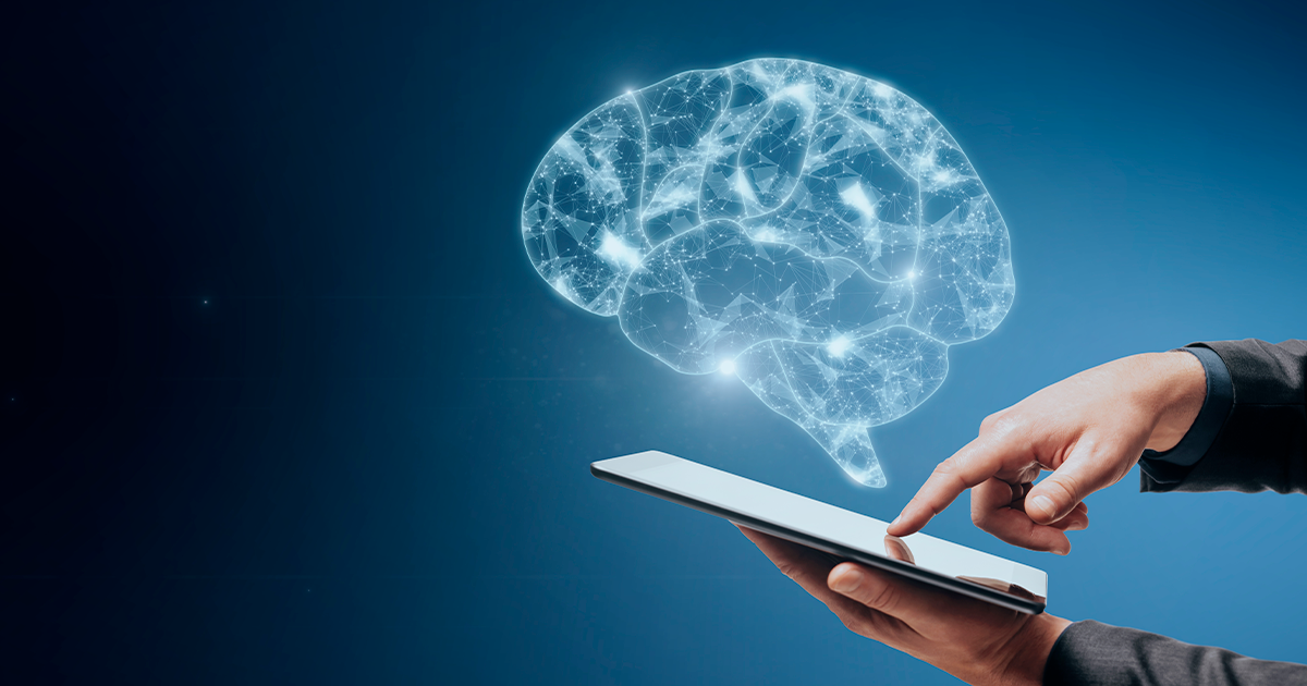 Close-up of a businessperson's hand pointing at a mobile phone displaying a wireframe brain against a blue background with a placeholder area. AI and computing concept.