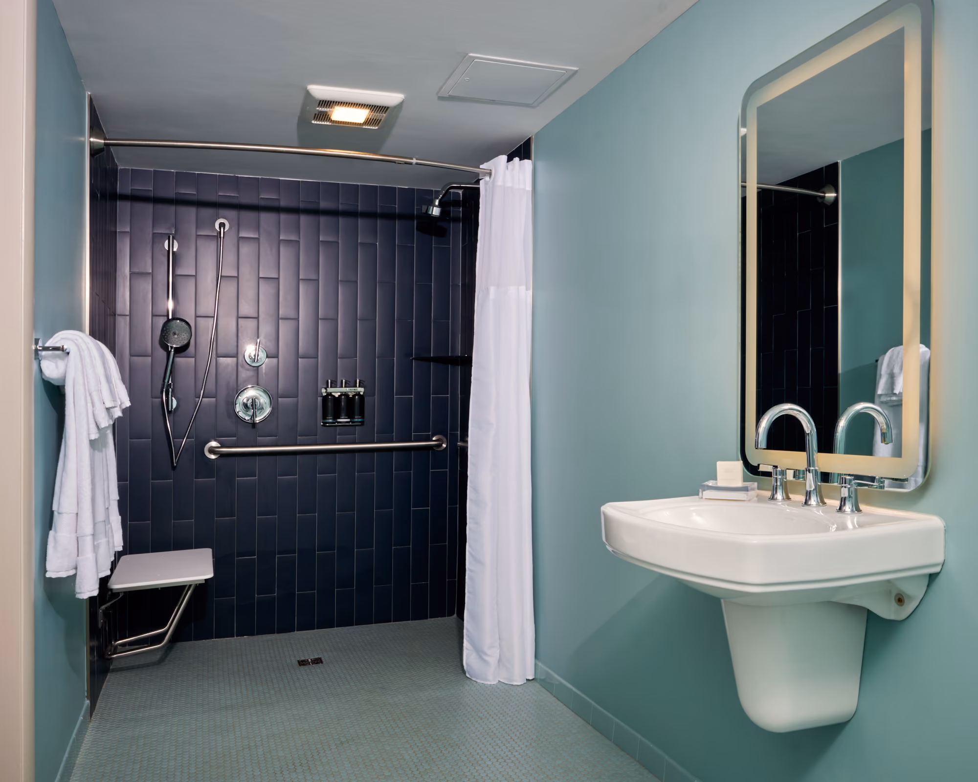 ADA bathroom with roll in shower at Colony House Motor Lodge